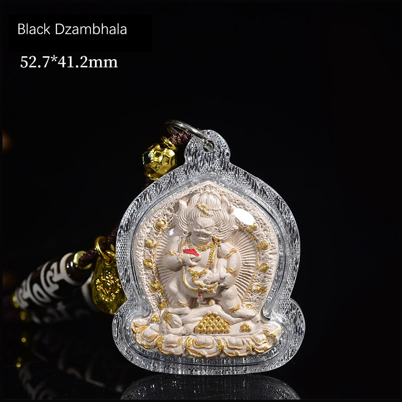 Black Dzambhala pendant, intricately carved,, symbolizing wealth and prosperity in Tibetan Buddhism.