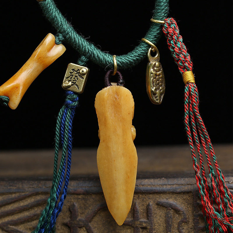Hand-carved Tibetan symbolic bone pendant
