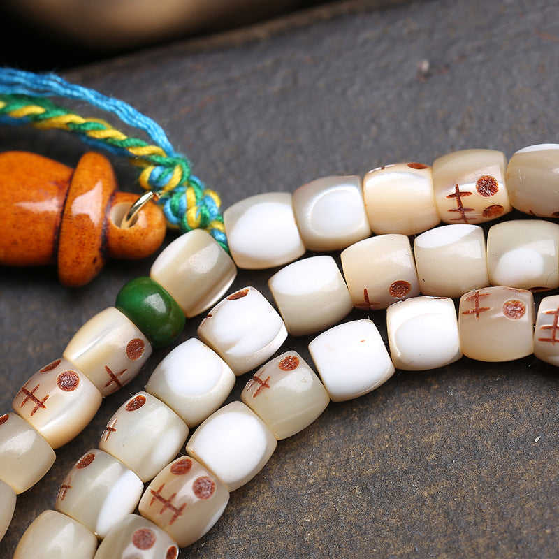 Premium natural bone bead 108 mala bracelet with antique style hand carved bone pendant, showing unique natural grain and texture