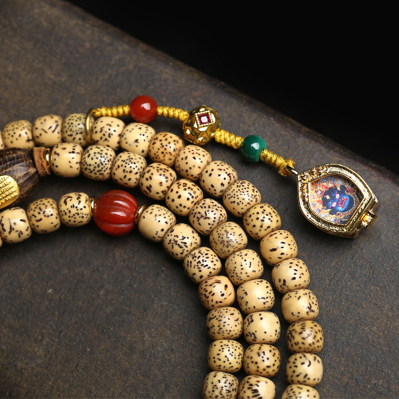 Close up of Tibetan aged seed star moon bodhi beads in creamy yellow color with natural patina