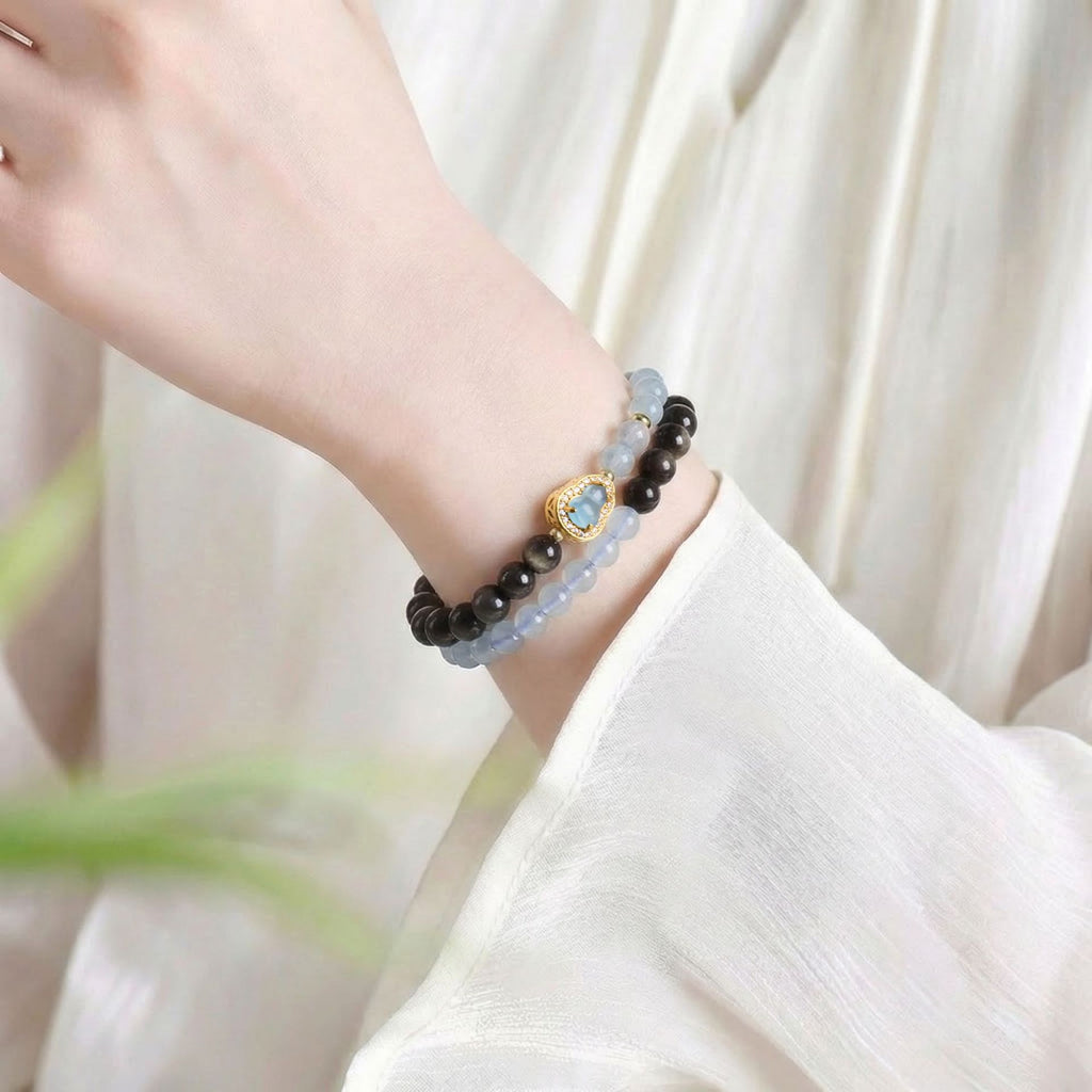 Double wrap bracelet worn on wrist, black obsidian and aquamarine healing beads