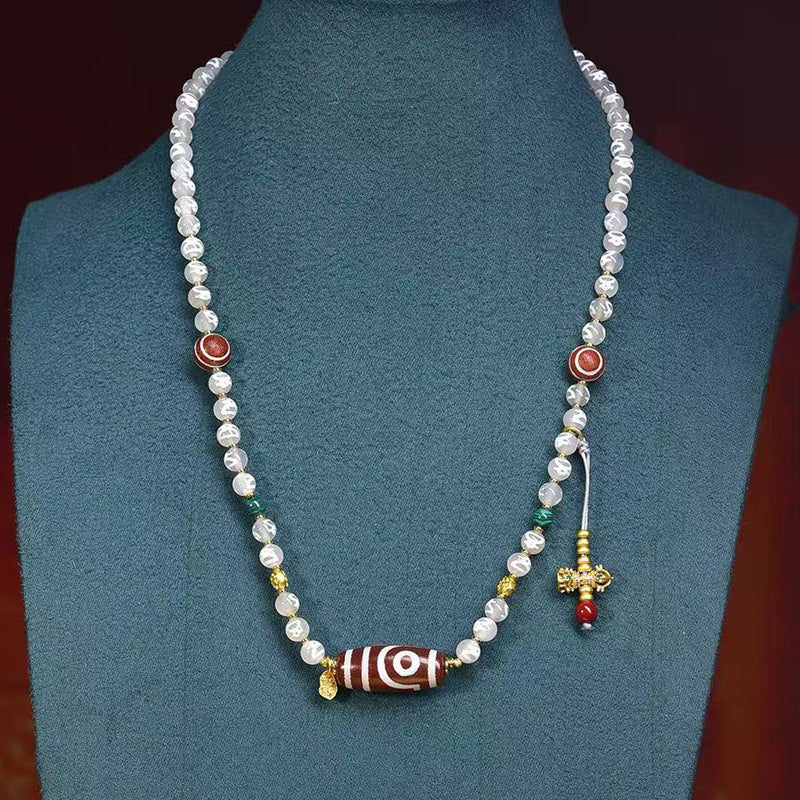 wearing Two-Eye Dzi Bead necklace for protection and harmony