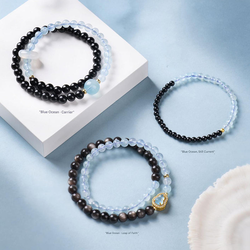 Black obsidian and aquamarine double wrap bracelet on neutral background