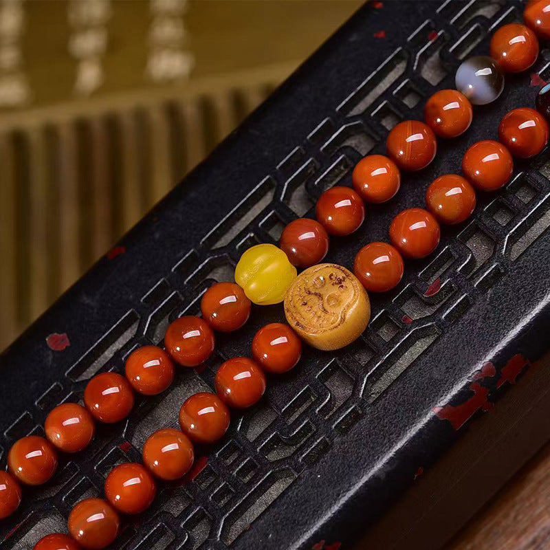 Close up detail of tibetan red agate 108 beads mala and colorful spacer beads