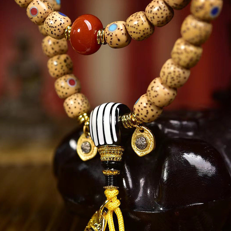 Close up of aged star moon bodhi beads with colorful gemstone inlay details