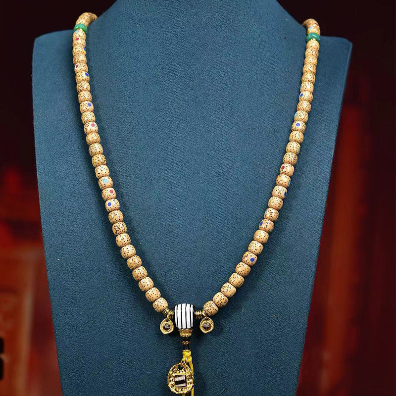 Aged star moon bodhi mala worn as multi-loop bracelet with Tibetan pendant