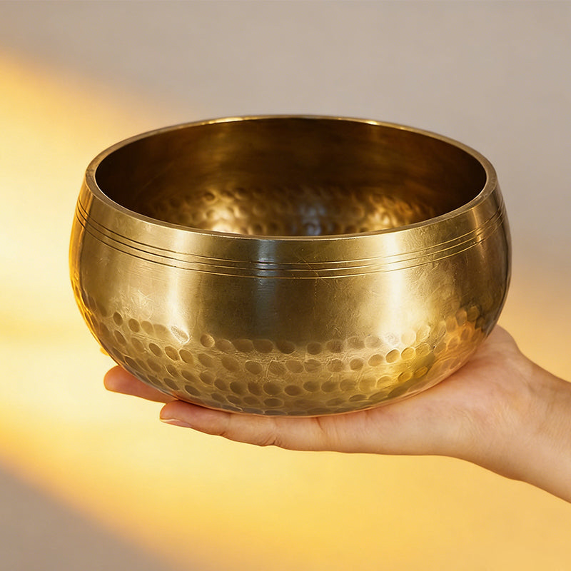 Side view of Tibetan singing bowl showing hammered metal finish and rim detail for sound healing meditation
