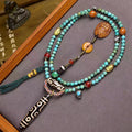 Tibetan turquoise 108 bead prayer mala with 9-eye dzi bead and Yellow Jambhala pendant