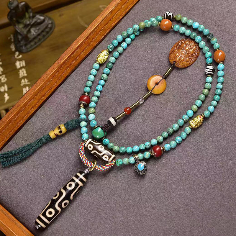 Tibetan turquoise 108 bead prayer mala with 9-eye dzi bead and Yellow Jambhala pendant