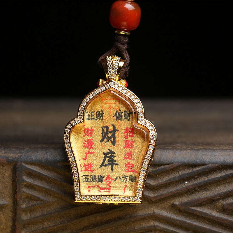 Close up of hand-painted Treasure House Thangka pendant on cotton canvas showing wealth symbols
