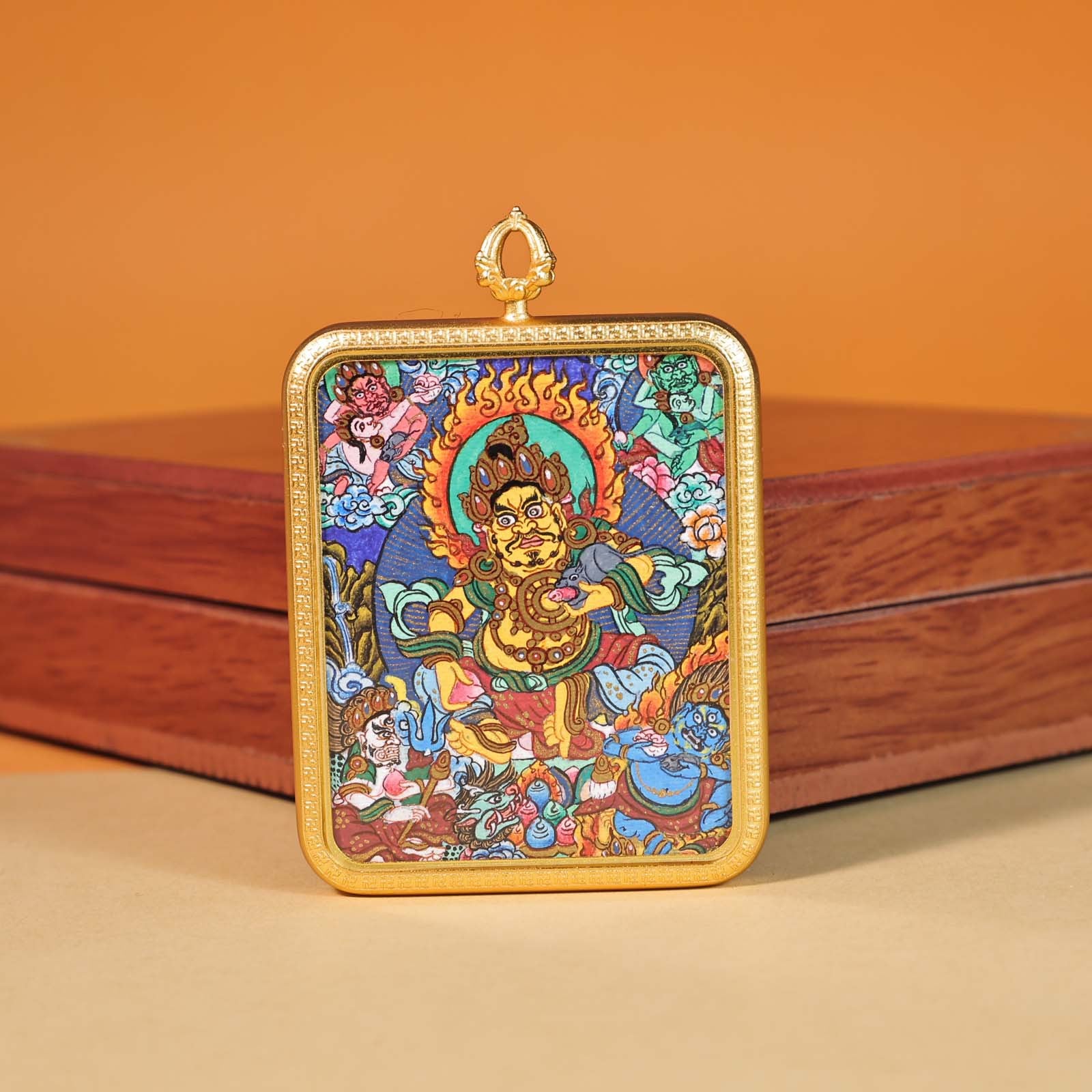 Close-up of hand-painted Yellow Jambhala miniature thangka showing gold details