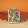 Yellow Jambhala miniature thangka placed on a traditional Buddhist altar